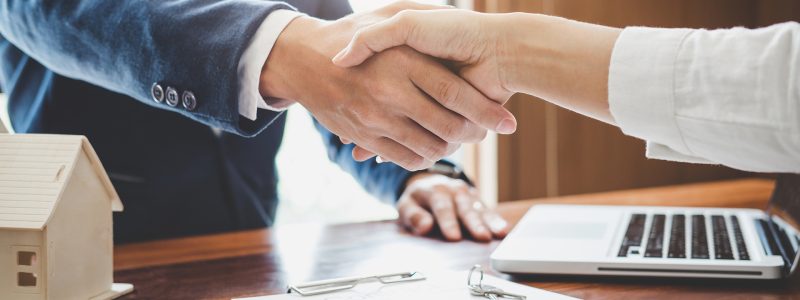 Real estate agent and customers shaking hands together celebrating finished contract after about home insurance and investment loan, handshake and successful deal Real estate agent and customers shaking hands together celebrating finished contract after about home insurance and investment loan, handshake and successful deal.
